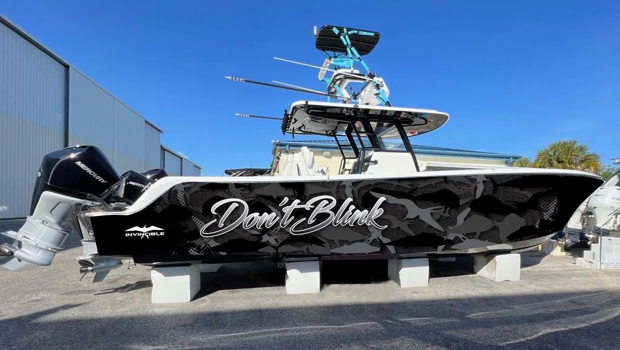 Invincible center console boat with a black camouflage Dont Blink wrap