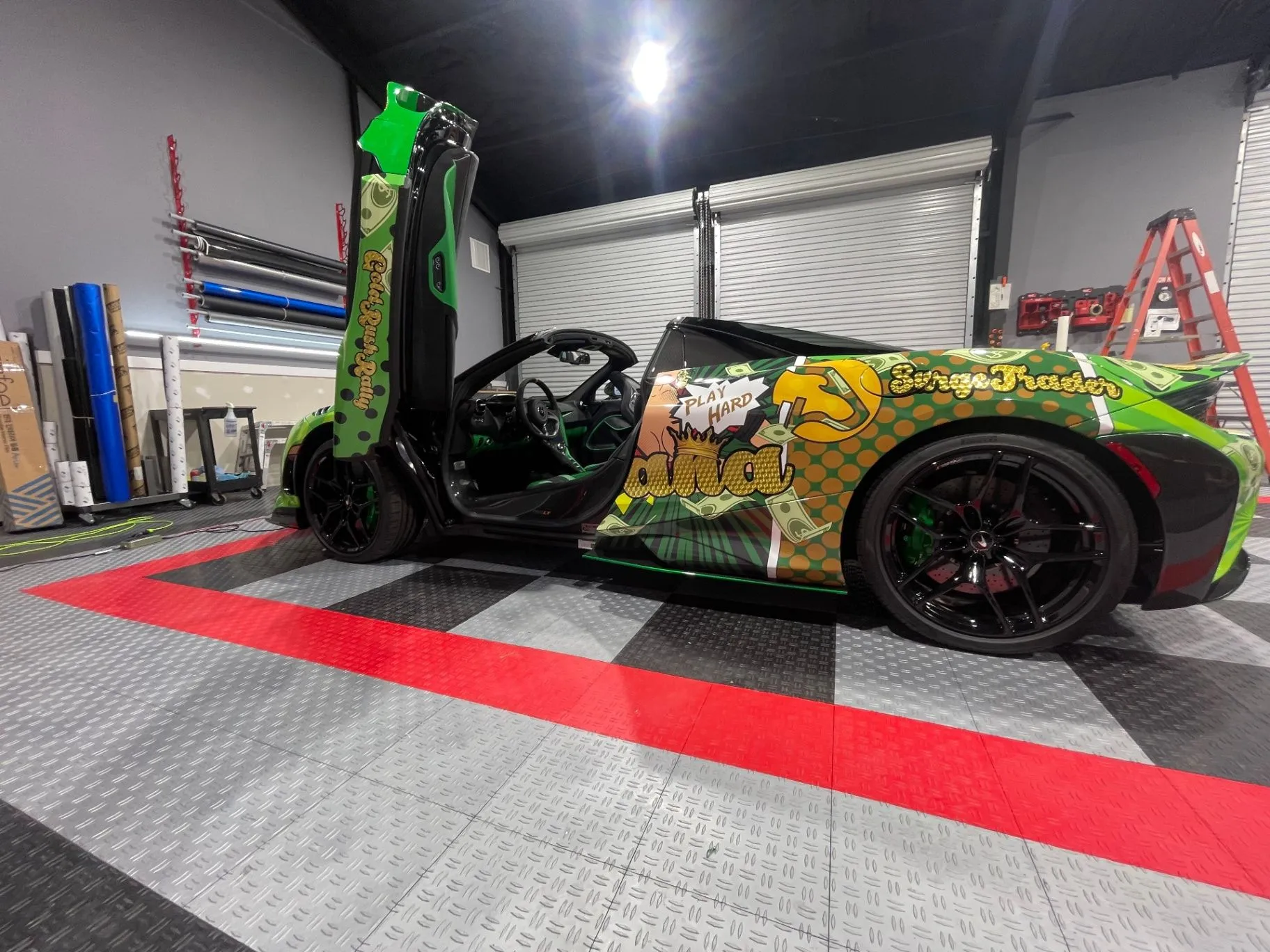 Green and gold sports car with a custom SurgeTrader wrap in the BJJ Graphics shop